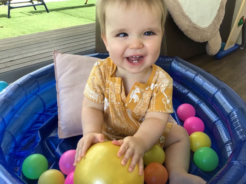 Max smiling in ball pit