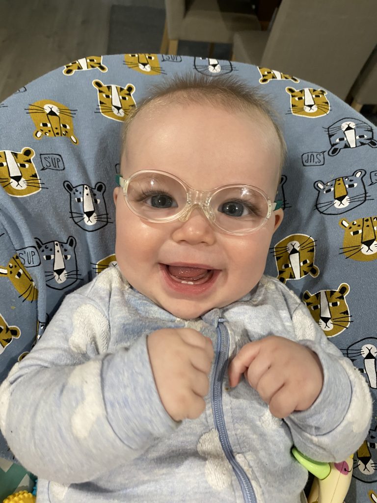 Max smiling in glasses in rocker