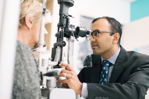 Dr Abhishek Sharma examing patient at Queensland Eye Institute